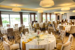 a banquet hall with tables and chairs and chandeliers at The Reed Hotel in Ninh Binh
