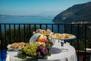 a table with two plates of food on a balcony at Villa Denise in Vico Equense