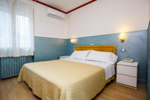 Postel nebo postele na pokoji v ubytování Hotel Diana