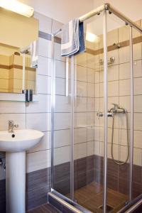 a bathroom with a shower and a sink at Ostria's House in Ratzaklíon