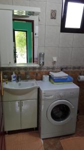 a bathroom with a washing machine and a sink at Apartments Penovic in Kotor