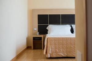 Postel nebo postele na pokoji v ubytování Hotel Diana