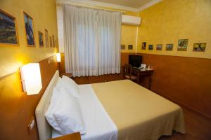Postel nebo postele na pokoji v ubytování Hotel Diana