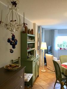 a living room with a green cabinet and a dining room at Ferienwohnung Hering in Dill in Dill