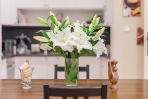 a vase of white flowers sitting on a table at Paulay Apartment in Budapest