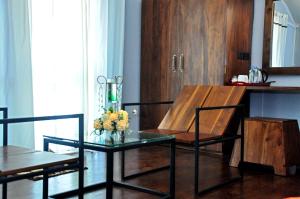 a living room with a table with a vase of flowers on it at Kottawatta Village in Udawalawe