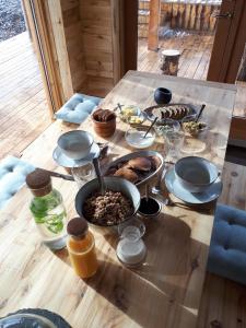 a wooden table with food on top of it at Móðir Jörð Organic B&B in Vallanes in Vallanes