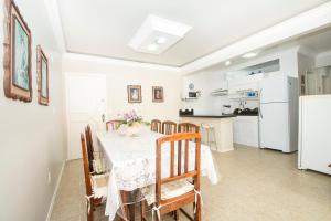 cocina y comedor con mesa y sillas en Apartamento Rua 1500, en Balneário Camboriú