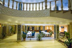 a patio with a table and chairs in a building at Karvon-Saroy Hotel in Andijan
