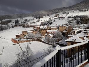 a town covered in snow on a mountain at Posada Torcaz in Cahecho +16 photos