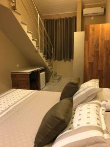 Cama ou camas em um quarto em Amoreiras Hotel Pousada