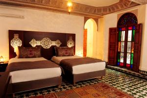 Postel nebo postele na pokoji v ubytování Riad El Amine Fès - Historic Hotels Worldwide