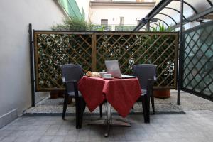 a table with a laptop sitting on top of it at Lux Hotel Durante in Milan +36 photos