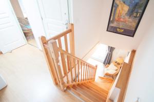 a staircase in a house with a dog sitting in a chair at L'amigeste in Pouzols-Minervois +32 photos