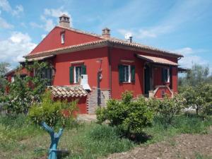 a red house in the middle of a field at Tenuta Sonia in Corigliano Calabro