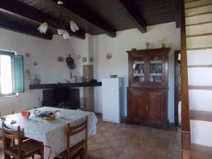 a kitchen with a table and a dining room with a table and chairs at Tenuta Sonia in Corigliano Calabro