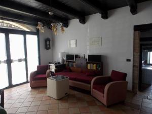 a living room with two red couches and a table at Tenuta Sonia in Corigliano Calabro