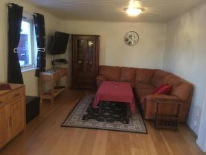 a living room with a couch and a table at Bed and Breakfast Hadeland in Harestua