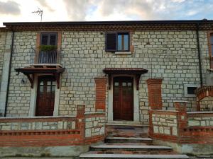 a brick building with two doors and a balcony at La Taverna in Morcone