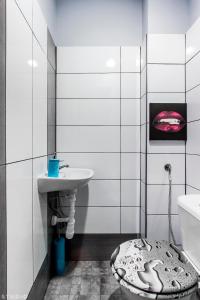 a bathroom with a toilet and a sink at ClickTheFlat Wspólna Central Apart Rooms in Warsaw