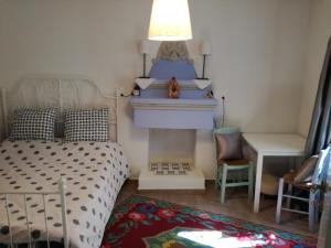 a bedroom with a bed and a fireplace at Beautiful cottage in Zagora in Zagora