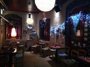 a dining room with tables and chairs and lights at Ξενώνας questhouse Electra isari in Isaris