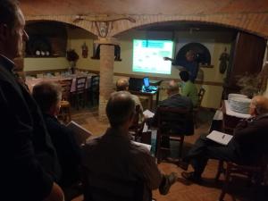 a group of people sitting in a room with a presentation at Agriturismo Loghino Sabbioni in Suzzara