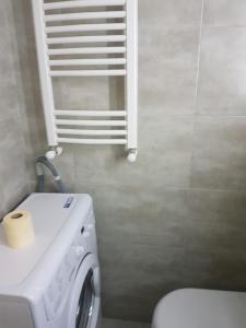 a bathroom with a white washer and dryer in it at The valley 309 in Nariani