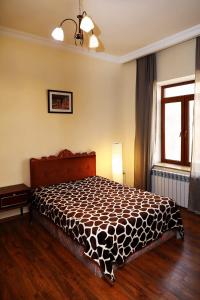- une chambre avec un lit et une couette noire et blanche dans l'établissement Apartments Aigedzor, à Erevan