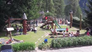 a group of people in a park with a playground at Familienpension Gletscherblick in Heiligenblut