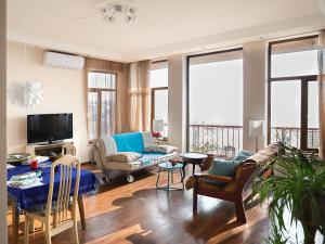 a living room with a couch and a table at Apartments Aigedzor in Yerevan