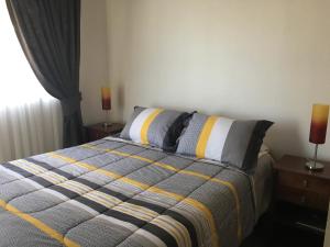 Postel nebo postele na pokoji v ubytování Departamento Concón