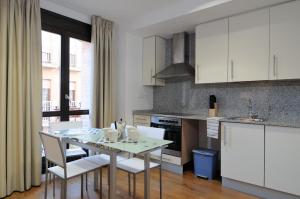 a kitchen with a table and chairs in a kitchen at Casa Palacio de los Sitios in Zaragoza