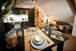 a kitchen and living room with a table with dishes on it at Bubble 8 in Épernay