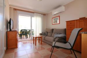 a living room with a couch and a table at OLIVA HOLIDAYS 1 in Oliva