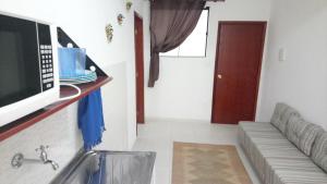 a kitchen with a sink and a microwave at Resende Flats GR in Resende