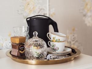 a tray with a tea pot and cups on it at Hilma Winblads Bed & Breakfast in Linköping
