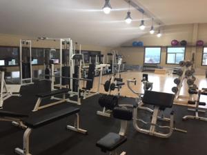a gym with several treadmills and machines in a room at Spruce Hill Resort & Spa in 108 Mile Ranch