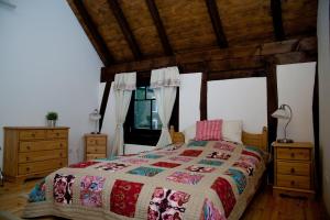 a bedroom with a large bed and a wooden ceiling at Hof Liebeneck in Osterspai
