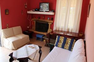 a living room with a couch and a fireplace at Prosilia Guesthouse in Prosília