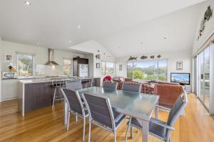 a kitchen and living room with a table and chairs at Seaside Pleasure in Apollo Bay