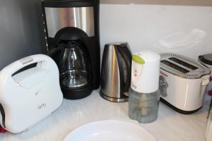 a counter top with a coffee maker and other appliances at Prosilia Guesthouse in Prosília