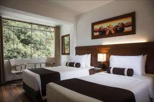 Hotel Ferre Machu Picchu tesisinde bir odada yatak veya yataklar