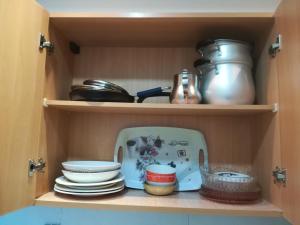 a cupboard filled with dishes and utensils at Loft Aziz in Tunis
