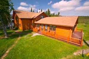 a home with a large yard with a house at Tuckamore Lodge in Main Brook