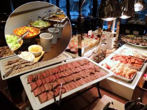 a buffet with many different types of food on display at Takaragawa Onsen Ousenkaku in Minakami