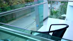 a chair sitting on top of a glass balcony at Hotel Sama in Montería