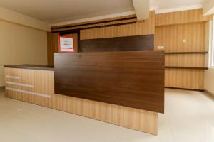 a wall of wood panels in a lobby at RedDoorz Plus near Palembang Square Mall in Palembang