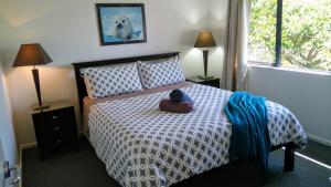 a bedroom with a bed with a dog on it at French Pass Beachfront Villas in Elmslie Bay