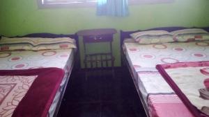 Postel nebo postele na pokoji v ubytování Sedulur Homestay